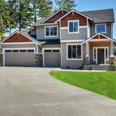 New suburban home with smooth concrete driveway, representing best time to pour concrete driveway conditions