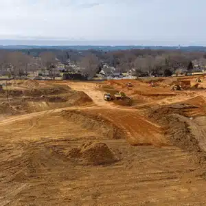 Wide view of leveled land prepared for building, showing scope that impacts excavation cost