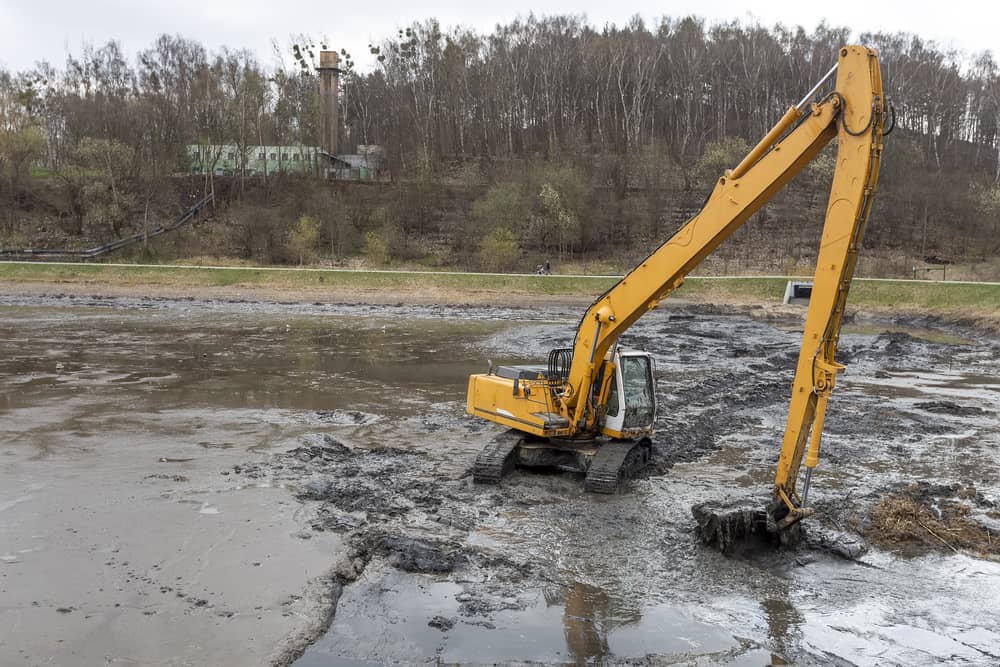 An excavator building a lake by digging